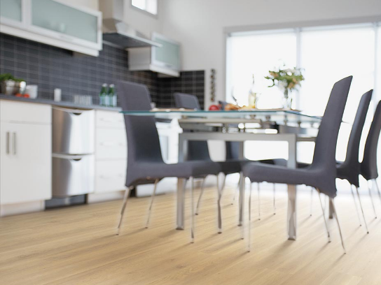 Light, natural wood-look laminate flooring adds brightness to a kitchen.
