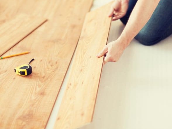 Flooring professional laying wooden flooring planks